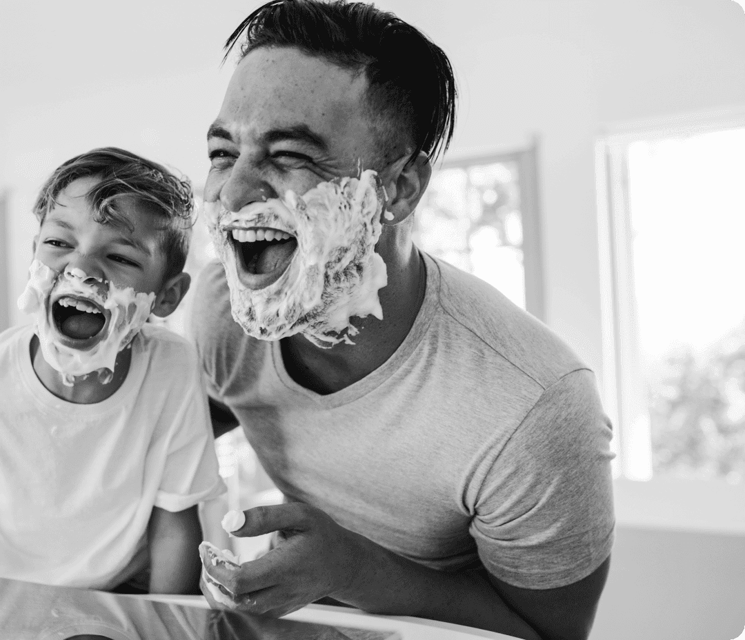 A Dad and son shaving their faces together A Dad and son shaving their faces together